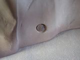 a close up of a shoe with a hole in it