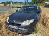 a black car that is parked in the grass