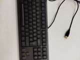 a computer keyboard and a mouse on a white table