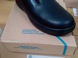 a black shoe that is on top of a box