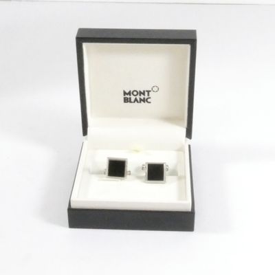 une paire de boutons de manchette noirs et blancs dans un coffret cadeau
