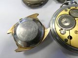 a close up of a pocket watch on a table