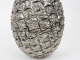a silver vase with a pineapple design on it