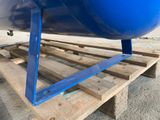 a large blue tank sitting on a pallet on the ground