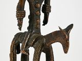 statue of a man sitting on a horse with a goat in front of him