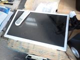 a television sitting on a pallet next to a remote control