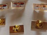 four lapel pins with the name of the air force on them