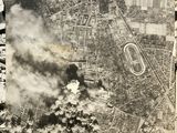 an old black and white photo of a city with smoke coming out of it