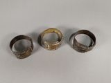 three different types of rings sitting on a white surface