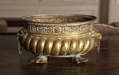 a large metal bowl on a table with a chain around it