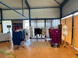 an image of a clothing store with a lot of clothes on display