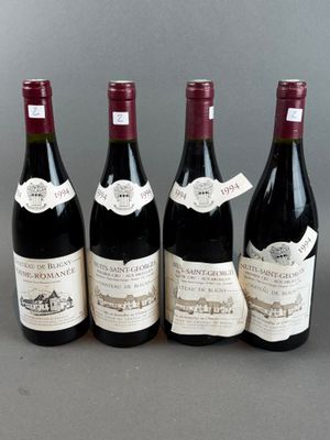 four bottles of wine are lined up on a table