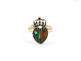 a close up of a ring with a beetle on it