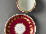 a close up of a cup and saucer on a table