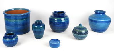 many blue vases that are sitting on a white surface