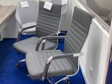 several office chairs are lined up in a room with blue carpet