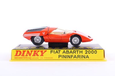 a red toy car sitting on top of a box
