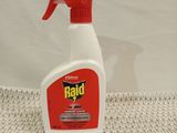 a close up of a bottle of raid insect repellent on a table