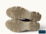 two pairs of shoes with a logo on the sole of them