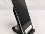 a cell phone that is on a stand on a table