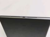 the back of a laptop computer sitting on top of a white table