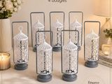 six decorative glass lanterns with laces on them sitting on a table