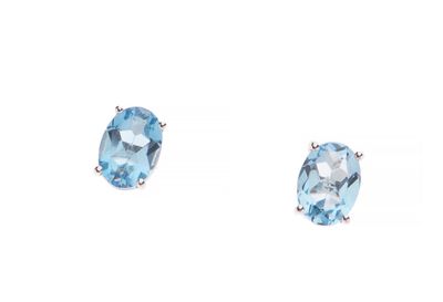 une paire de boucles d'oreilles en topaze bleue sur fond blanc