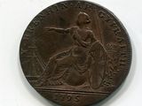 une vieille pièce de monnaie sur laquelle figure l'effigie d'une femme