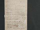 an old document with writing on it sitting on top of a table