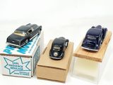 three toy cars sitting on top of a cardboard box