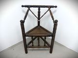 a wooden chair that is sitting in a corner