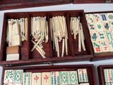 a lot of dominos in a wooden box on a table