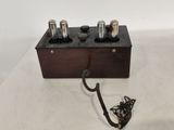 an image of a wooden box with three different types of electronic devices on top of it