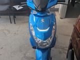 a blue scooter that is parked in a garage
