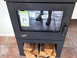a black stove with logs stacked on top of it