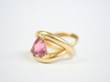 a close up of a gold ring with a pink tourmaline stone