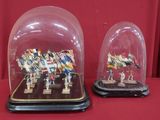 two glass cloches that have been placed on a table