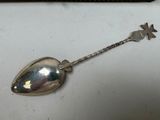 a spoon with a star on it sitting on a table