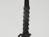 wrought iron candle holder with a twisted design on a white background