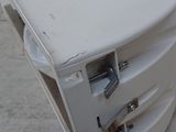 a white microwave sitting on top of a pile of wood