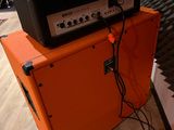 an orange amp sitting on top of a black amp