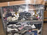 a metal cart with a bunch of shoes inside of it