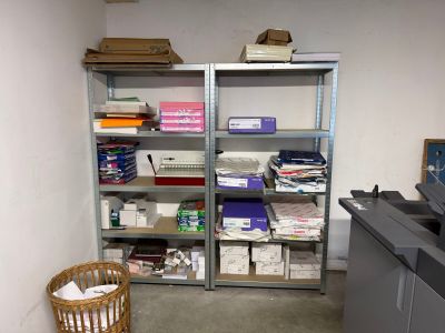 a room that has a bunch of boxes on the shelves
