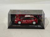 a red car in a clear box on a white surface
