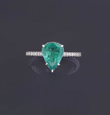 a pear shaped emerald and diamond ring