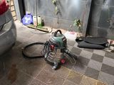 a vacuum that is on the floor next to a car