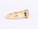 an image of a yellow gold ring with a sapphire and diamonds