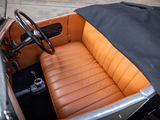 an old car with a leather seat and steering wheel