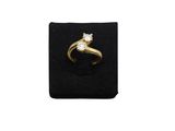 a yellow gold ring with a diamond on a black velvet ring holder