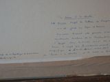 a piece of paper on the wall with writing on it